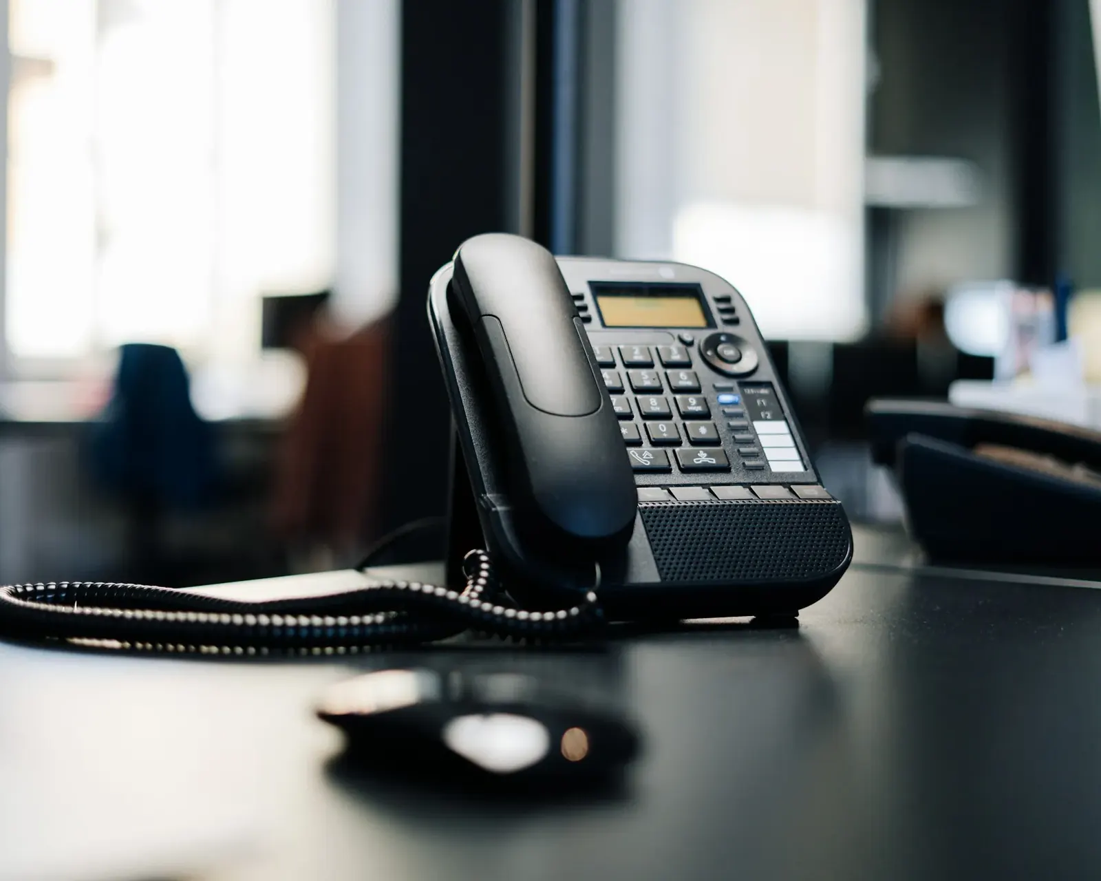 Black desk telephone on an office desk